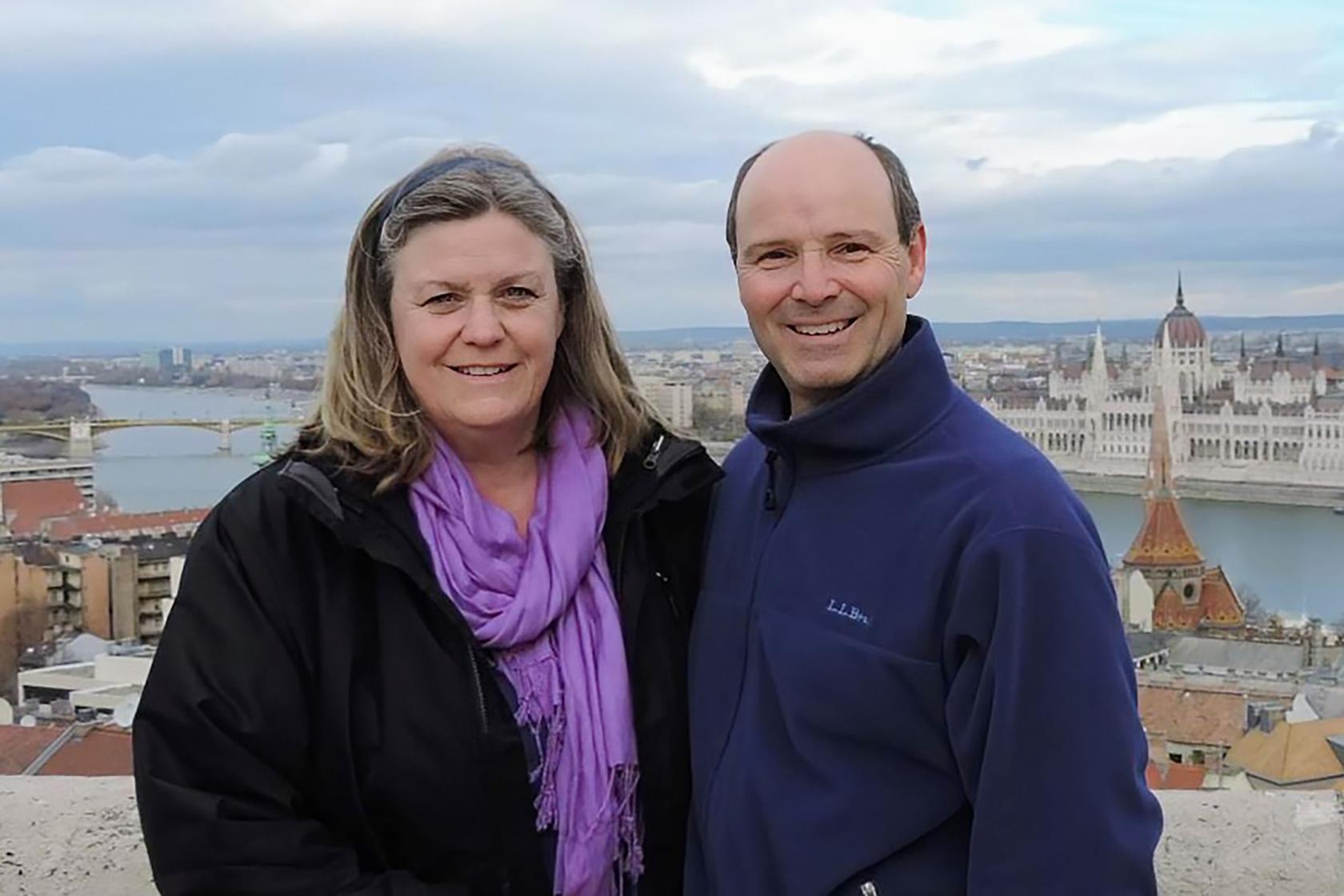 A man and woman with a scenic view behind them