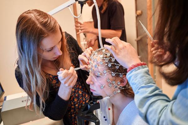Students prepare a test subject for a brain scan in the neuroscience laboratory in Olin Hall.