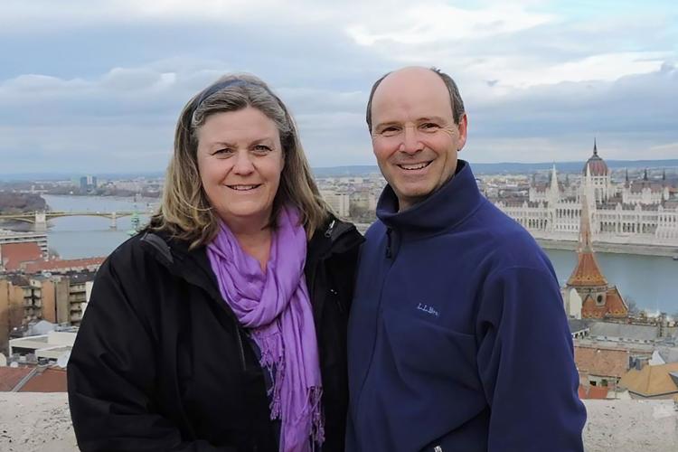 A man and woman with a scenic view behind them