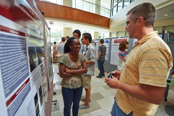 Students interact at a poster sessions in Ho Science Center