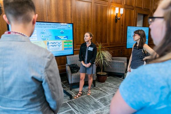 Student presenting at a screen