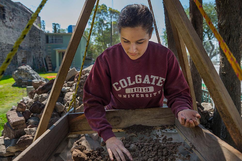 Anthropology student digging through sediment